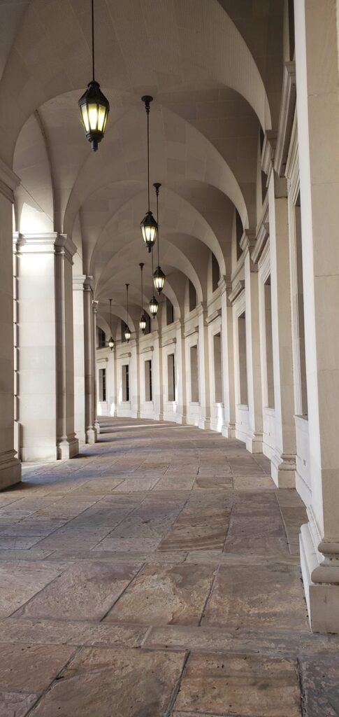 A long walkway with many columns and lights