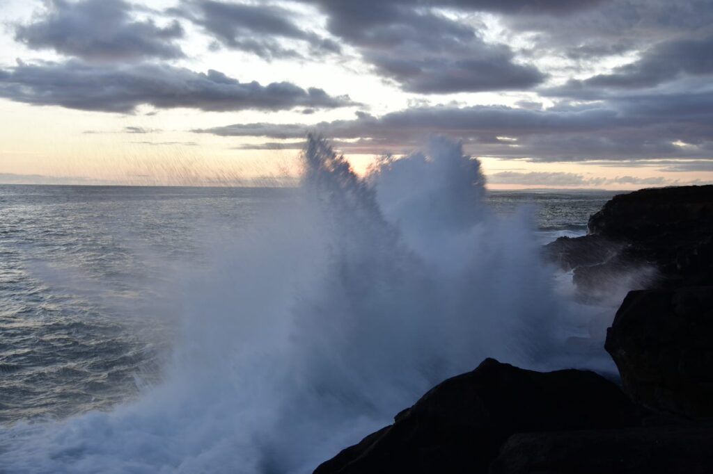 A wave crashing on the rocks of the ocean.