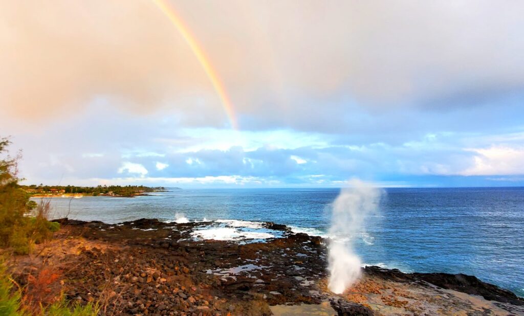 A rainbow over the ocean and a spray of water