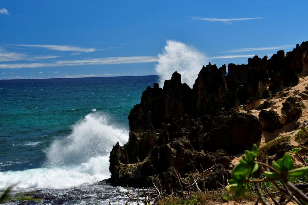 A wave crashing on the rocks of a beach