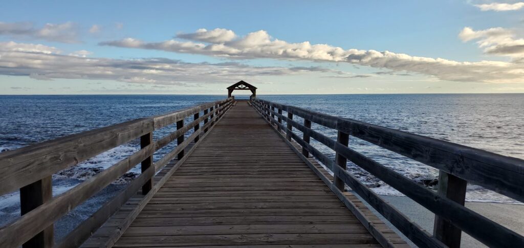 A pier with a bench on the end of it